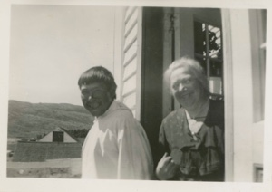 Image: Mrs. Paul Hettasch in doorway of her home, with Eskimo [Inuk] man